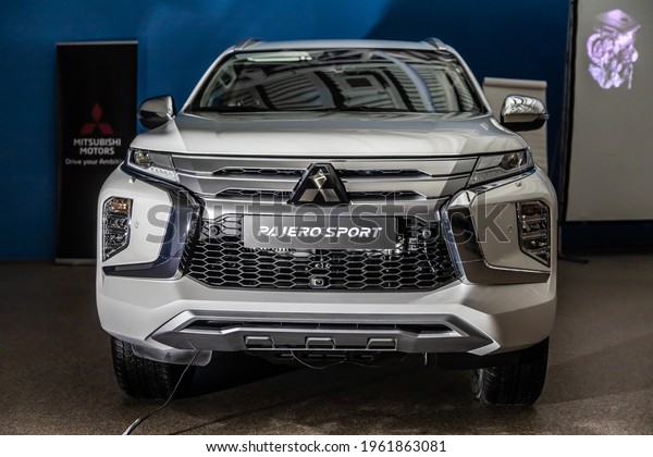 Moscow, Russia - February 17, 2021: All new Mitsubishi\
Pajero Sport. Montero. Car stand at the parking box, dark light.\

