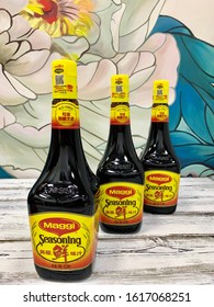 Moscow, Russia, February 18, 2019, City Food Market, Chinese Goods Store.SEASONING Soy Sauce Of The Maggi Brand, In A Glass Bottle With A Yellow Label. On A Wooden Table