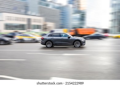 Moscow, Russia - February 2022: Car Audi E-tron On The Road In Motion. Fast Speed Drive On City Road With Blurred Urban Background