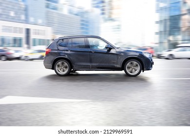 Moscow, Russia - February 2022: Fast Moving BMW X3 F25 On The City Road. Black SUV With Man Driving. Luxury Auto In Fast Motion With Blurred Background. Speeding In The City Concept