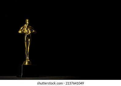 Moscow, Russia - February, 2022: Hollywood Golden Oscar Academy award statue against black background.