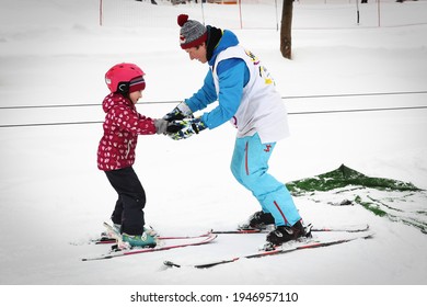 Moscow, Russia, February 25, 2021: Alpine skiing master class for kids with instructor in winter sports school for children.
