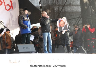 Moscow, Russia - February 4, 2012. Politician Sergei Udaltsov Launched A Portrait Of Vladimir Putin On The Stage Of Opposition Rally