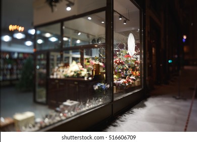 Moscow, Russia. Flower Shop Window At Night. The Pavement Is Covered With Snow