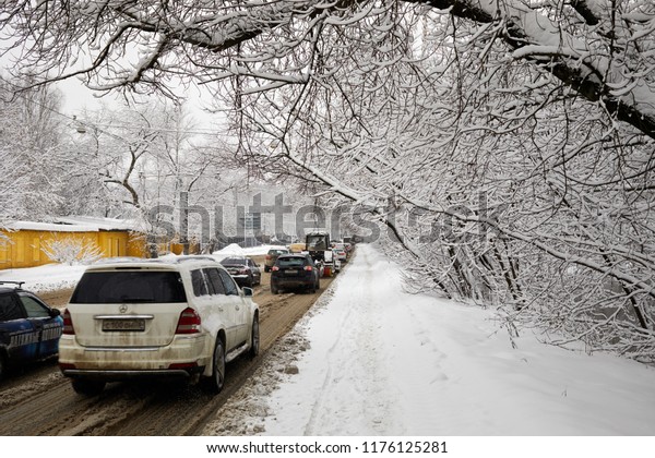 MOSCOW, RUSSIA - JAN 31, 2018: Cars on\
Bogatyrsky Bridge street on winter snowy\
day.