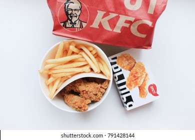 MOSCOW, RUSSIA - JANUARY 11, 2018: KFC Fast Food Meal Top View. Kentucky Fried Chicken Nuggets Bucket and French Fries Take Out Food. KFC is a Worldwide Famous American Fastfood Restaurant.