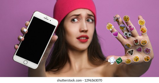 Moscow, Russia - January 15, 2019: Young Woman With Popular Social Mobile Emoji Smiles Stickers For Cellphone Android Or IPhone On Her Hand Surprised Show Blank Screen Of Mobile