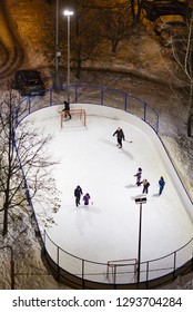 MOSCOW, RUSSIA - JANUARY 20, 2019: Typical Moscow Yard With Skating Rink In Commuter Town Area As Viewed From Above. Children And Parents Skating And Playing Hockey In The Evening