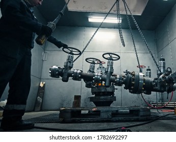 Moscow, Russia - January 23, 2019: Assembling a well at the oil equipment plant. The connection of the valves and other well parts in the assembly hall.
