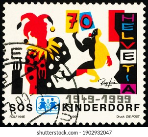 Moscow, Russia - January 26, 2021: Stamp Printed In Switzerland Shows Jester And Clown, Dedicated To The 50th Anniversary Of The SOS Children`s Village, Circa 1999