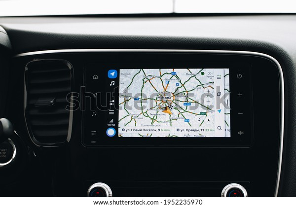 MOSCOW, RUSSIA -\
JANUARY 30, 2021 Mitsubishi Outlander dark interior view. Close up\
view of a car media dashboard screen with yandex auto software. Map\
view on the screen. 