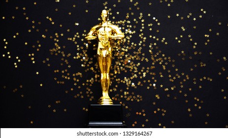 Moscow, Russia - January 31, 2019: oscar gold statue trophy on a black background, symbol of the victory of the actor in his profession. editorial