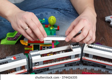 MOSCOW, RUSSIA - January 4, 2016: Man Hands Playing With Town Built Of Lego 