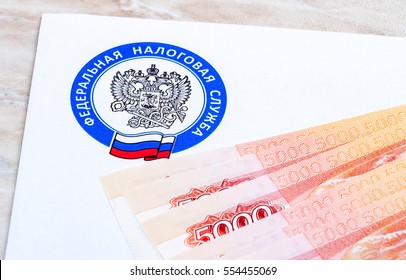 MOSCOW, RUSSIA - JANUARY 9, 2017: Tax Payment Notice Letter With Logo Of The Federal Tax Service Of Russia And Ruble Banknotes Above. Tax Payment Concept