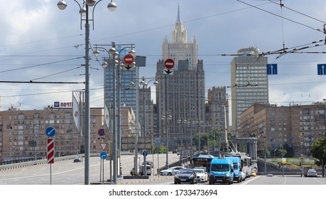 Moscow, Russia - July 10, 2017: Moscow Skyline. Street With Columned Cars In Front Of The Golden Ring Hotel And The Famous Skyscraper Of The Russian Ministry Of Foreign Affairs.