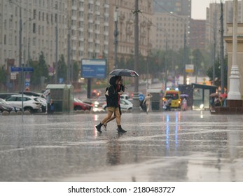 Moscow, Russia - July 10, 2022: Raining Day In City Center At Summer. Wet People Under Umbrella. Texture Of Strong, Fresh And Powerful Water Drops And Sprays. Tropical Storm