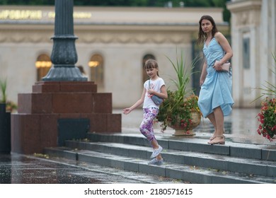 Moscow, Russia - July 10, 2022: Raining Day In City Center At Summer. Wet People.  Texture Of Strong, Fresh And Powerful Water Drops And Sprays. Tropical Storm