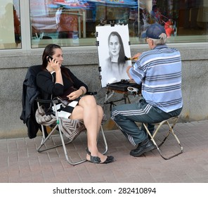 MOSCOW, RUSSIA - JULY 18, 2013: Street artist draws a girl on famous Arbat in Moscow, Russia - Shutterstock ID 282410894
