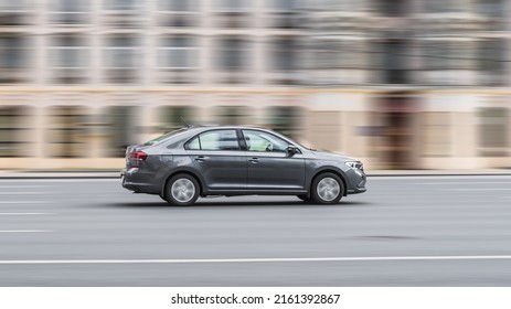 Moscow, Russia - July 2021: car Volkswagen Polo Mk6 Sixth generation moving on the street on high speed. Gray auto driving along city street with motion blurred background.