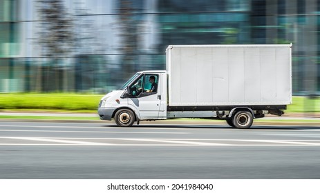 Moscow, Russia - July 2021: Ford Transit Cargo Box Van Truck In The City Street. Side View Of White Light Commercial Vehicle In Motion