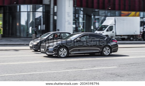 Moscow,\
Russia - July 2021: Genesis G80 on the street in motion. Front side\
view of a premium Korean car, luxury black\
sedan