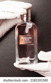 Moscow, Russia July 23,2022: Abercrombie Fitch Perfume Water First Instinct Woman Hands In White Gloves Holding Glass Perfume Bottle