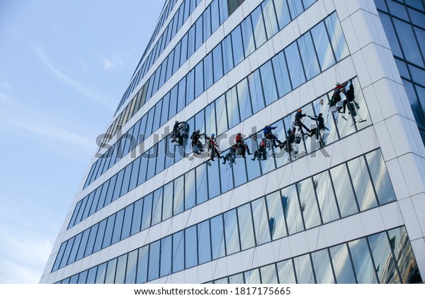 Moscow, Russia, July 24, 2020: Industrial climbers wash\
the Windows of a modern skyscraper. men wash Windows on the\
evolution tower in Moscow City. window Cleaners wash the glass\
facade. 