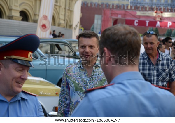 MOSCOW,\
RUSSIA — JULY 26, 2014: Leonid Parfyonov Russian journalist, news\
presenter, TV producer and author of many documentary TV shows at\
old cars public exhibition event nearby GUM\
store