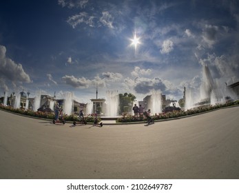 MOSCOW, RUSSIA - JULY 29, 2021: Tourists viewing the Stone Flower fountain at the Exhibition Center VDNH in summer sunny day in Moscow, Russia on July 29, 2021.