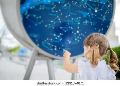 MOSCOW, RUSSIA - JULY 6 2018: Outdoor Exhibition In Moscow Planetarium. Little Girl Looking At The Exhibits.