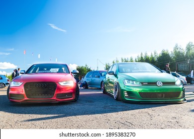 Moscow, Russia - July 6, 2019: Red Audi A4 and Green Volkswagen Golf. sports and tuned cars are parked in the parking lot. Alloy wheels and lowered suspension