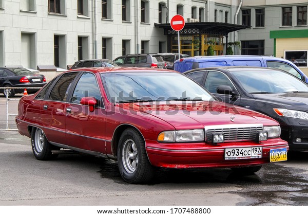 Moscow, Russia - July 7, 2012: Red\
American saloon car Chevrolet Caprice in the city\
street.