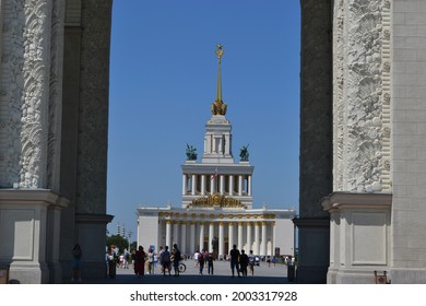 Moscow, Russia, July 7, 2021. View of the main entrance of VDNKh and people walking on a hot summer day