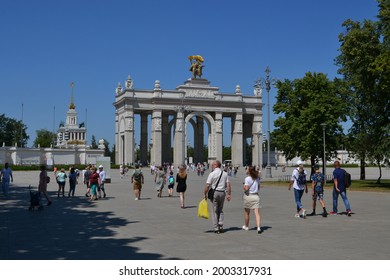 Moscow, Russia, July 7, 2021. View of the main entrance of VDNKh and people walking on a hot summer day