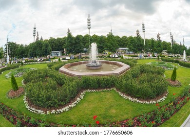 Moscow, Russia - July 9, 2020: The Exhibition Of Achievements Of National Economy (VDNKh/VDNH). People Walking In The Public Park In Summer Day. Weekend And Holidays Theme. Fish Eye Lens