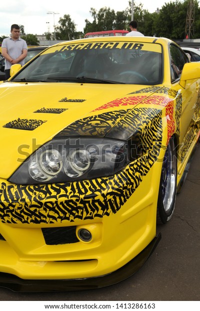 MOSCOW, RUSSIA - JUNE 1, 2019: Open automobile\
festival of Stance culture in Podsolnukhi Art&Food center,\
Moscow city, Russia. Tuning yellow car. Art car by Pokras Lampas.\
Customized Toyota Supra\
car