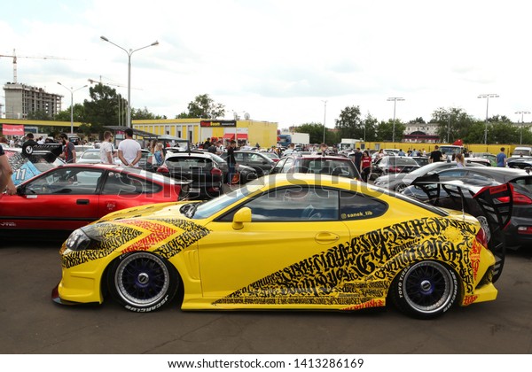 MOSCOW, RUSSIA - JUNE 1, 2019: Open automobile\
festival of Stance culture in Podsolnukhi Art&Food center,\
Moscow city, Russia. Tuning yellow car. Art car by Pokras Lampas.\
Customized Toyota Supra\
car