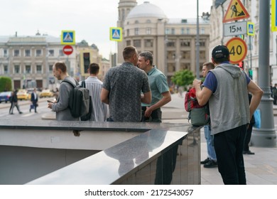 Moscow, Russia - June 1, 2022: Group Of People On The City Street. They Standing Near The Underground Pedestrian Crosswalk. Backs, Rear View. Lifestyle Concept. Men Only