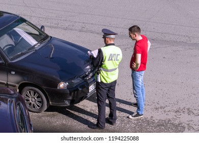 Moscow, Russia - June 10, 2018: A Traffic Police Inspector Checks Documents With A Driver