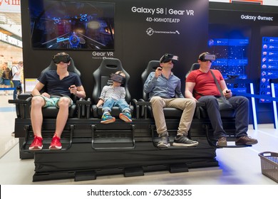 Moscow, Russia - June 11, 2017: People With An Immersive VR Content Viewing Experience At Samsung Gear VR Theater With 4D Chair In Modern Interactive Space Galaxy S8 Studio In Megapolis Shopping Mall.