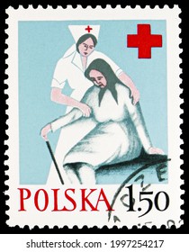 MOSCOW, RUSSIA - JUNE 11, 2021: Postage Stamp Printed In Poland Shows Nurse Helping Old, Polish Red Cross Serie, Circa 1977