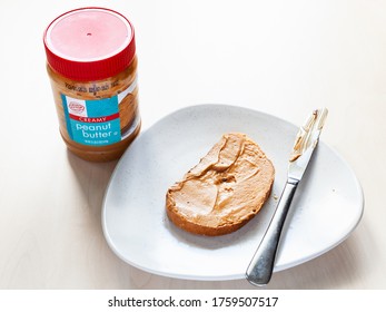 MOSCOW, RUSSIA - JUNE 16, 2020: Closed Jar Of Hy-Top Creamy Peanut Butter And Toast With Spread On Plate On Table. HyTop Is Brand Of Private Label Groceries Created In The 1950 In Illinois, USA