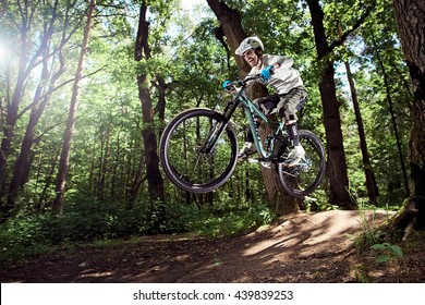 MOSCOW, RUSSIA - JUNE 20, 2016: Rider In Action At Mountain Bike Sport. Jump On A Mountain Bike. Biker Making A Stunt And Jumps In The Forest. Cool Athlete Cyclist On A Bike. MTB Biking.