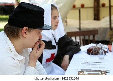 Moscow, Russia - June 2019: Army Doctor And Nurse Of The Russian Empire Of 19th Century Sitting In A Military Field Hospital During The Moscow Historical Festival Times And Epochs