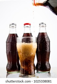 MOSCOW, RUSSIA - JUNE 22, 2012: Coke, Glass, Wet.Three Coke Glass Bottles, Isolated On White Background. Illustrative Editorial. Plastic Bottle Above