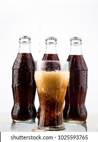 MOSCOW, RUSSIA - JUNE 22, 2012: Coke, Glass, Wet.Three Coke Glass Bottles, Isolated On White Background. Illustrative Editorial. Plastic Bottle Above