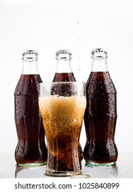 MOSCOW, RUSSIA - JUNE 22, 2012: Coke, Glass, Wet.Three Coke Glass Bottles, Isolated On White Background. Illustrative Editorial. Plastic Bottle Above