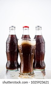 MOSCOW, RUSSIA - JUNE 22, 2012: Coke, Glass, Wet.Three Coke Glass Bottles, Isolated On White Background. Illustrative Editorial. Plastic Bottle Above