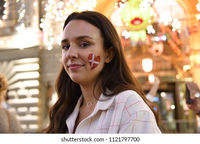 Moscow, Russia - June 26, 2018: Danish Girl Football Fan On The Night Streets Of Moscow. Soccer Fans From Abroad Walking Down The Nikolskaya Streets, FIFA World Cup, Mundial 2018