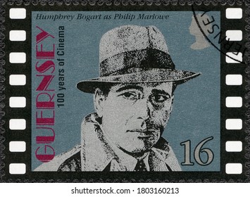 MOSCOW, RUSSIA - JUNE 26, 2020: A stamp printed in Guernsey shows Humphrey DeForest Bogart (1899-1957), actor, Motion Pictures Century, 1996